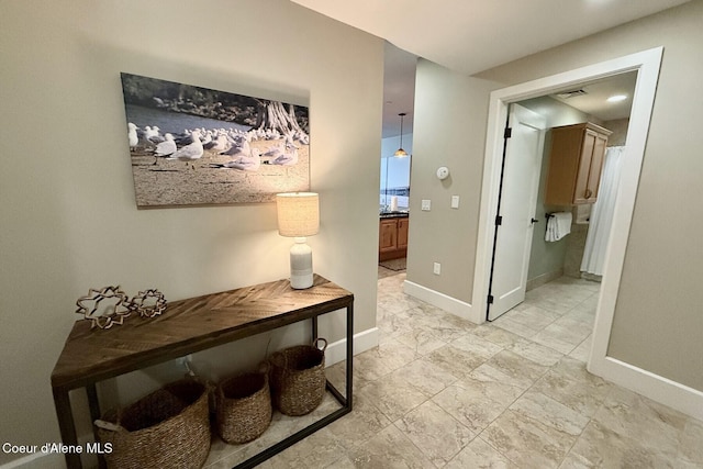 hall featuring baseboards