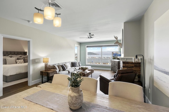 dining space with wood finished floors, ceiling fan, and baseboards