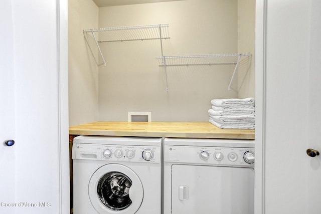 clothes washing area with washing machine and clothes dryer
