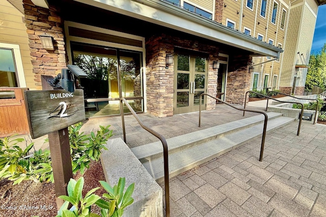 view of exterior entry with french doors and stone siding