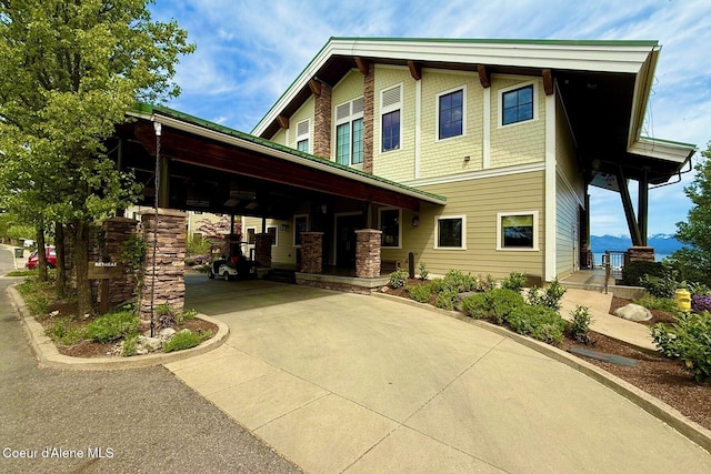 view of property exterior featuring driveway, a porch, and a carport