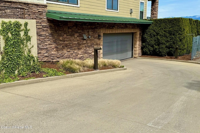 garage featuring concrete driveway