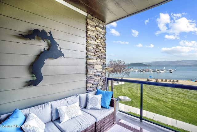 balcony featuring a water and mountain view