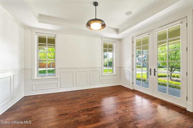 2484 E Woodstone Dr, Hayden, ID 83835 - unfurnished room featuring french doors, plenty of natural light, a tray ceiling, crown molding, and dark wood-style flooring