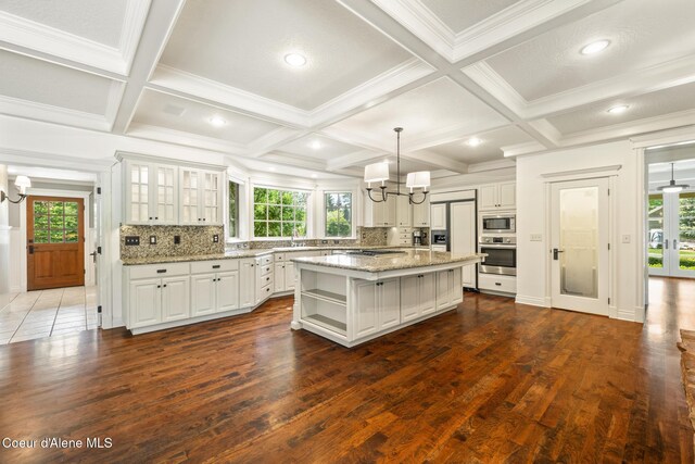 2484 E Woodstone Dr, Hayden, ID 83835 - kitchen with stainless steel appliances, a chandelier, plenty of natural light, beamed ceiling, and coffered ceiling