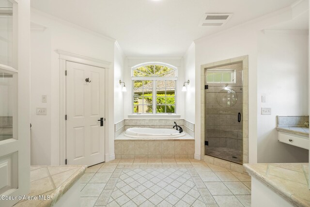 2484 E Woodstone Dr, Hayden, ID 83835 - full bathroom with a garden tub, a shower stall, tile patterned floors, ornamental molding, and inlaid floor details