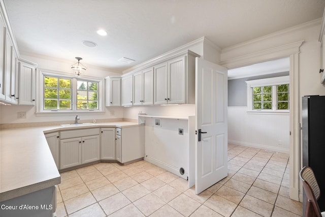 2484 E Woodstone Dr, Hayden, ID 83835 - kitchen featuring freestanding refrigerator, a sink, wainscoting, light tile patterned floors, and healthy amount of natural light