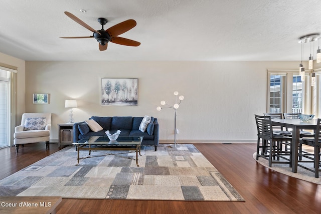4445 W Greenchain Loop Unit 2, Coeur Dalene, ID 83814 - living area with wood finished floors, a ceiling fan, baseboards, and a textured ceiling