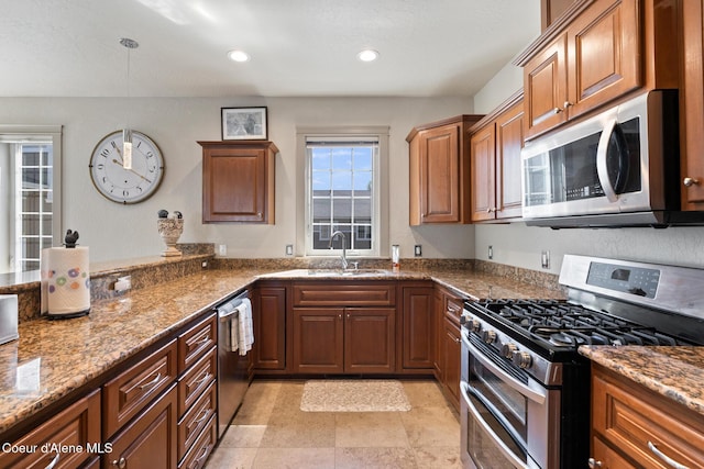 4445 W Greenchain Loop Unit 2, Coeur Dalene, ID 83814 - kitchen featuring stainless steel appliances, a sink, stone countertops, brown cabinets, and recessed lighting