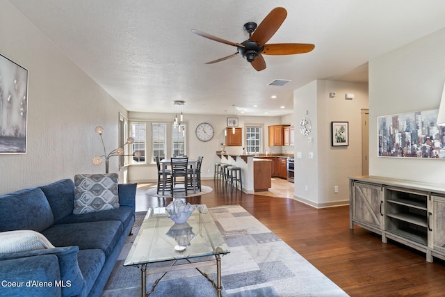 4445 W Greenchain Loop Unit 2, Coeur Dalene, ID 83814 - living area with dark wood finished floors, ceiling fan, and baseboards