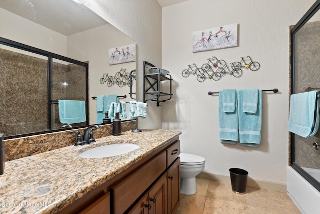 4445 W Greenchain Loop Unit 2, Coeur Dalene, ID 83814 - bathroom with vanity, toilet, tile patterned floors, bath / shower combo with glass door, and baseboards