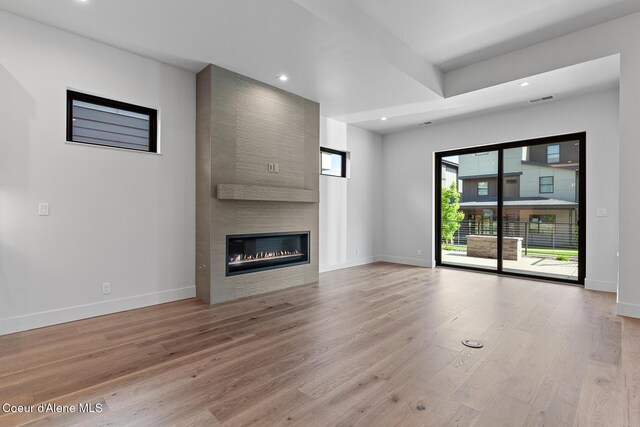 2867 W Lumber Ln, Coeur Dalene, ID 83814 - unfurnished living room featuring baseboards, light wood-style floors, a large fireplace, and recessed lighting