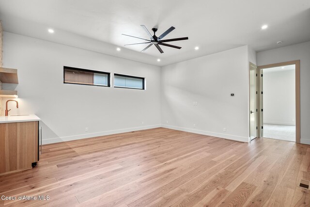 2867 W Lumber Ln, Coeur Dalene, ID 83814 - unfurnished bedroom featuring recessed lighting, light wood-style floors, baseboards, a sink, and a ceiling fan