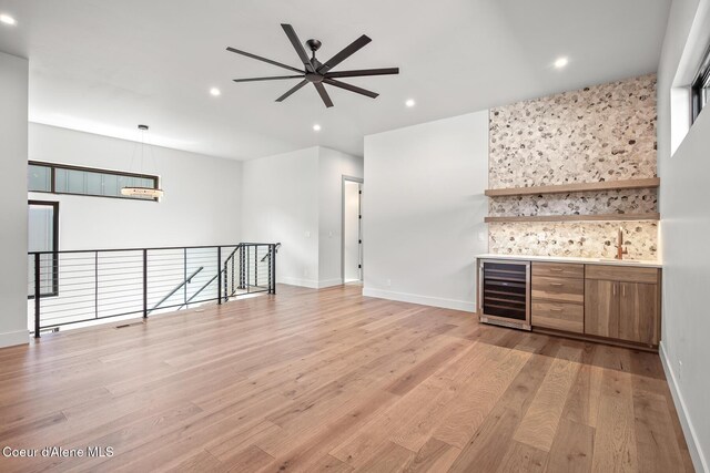 2867 W Lumber Ln, Coeur Dalene, ID 83814 - indoor bar featuring beverage cooler, light wood-style flooring, ceiling fan, recessed lighting, and baseboards