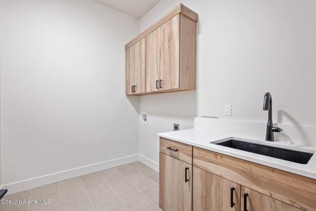 2867 W Lumber Ln, Coeur Dalene, ID 83814 - laundry room featuring hookup for an electric dryer, hookup for a washing machine, cabinet space, baseboards, and light tile patterned floors