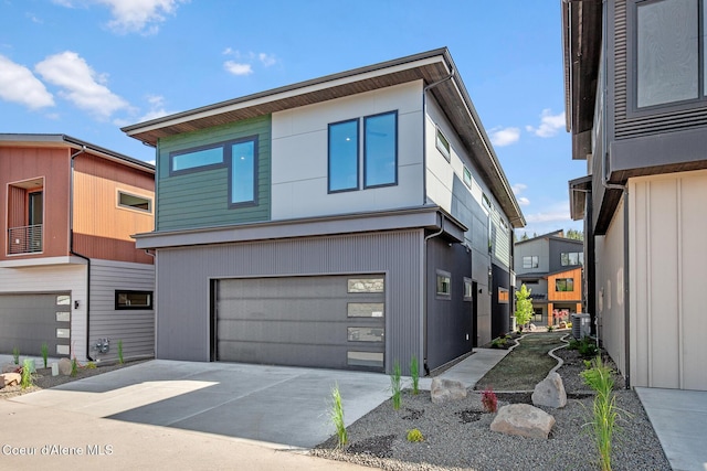 2867 W Lumber Ln, Coeur Dalene, ID 83814 - modern home with a garage, concrete driveway, and central air condition unit
