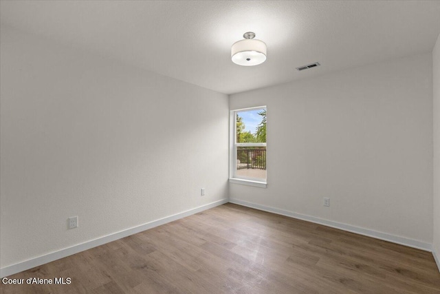 1303 N Cherrywood Dr, Coeur Dalene, ID 83814 - empty room with wood finished floors and baseboards