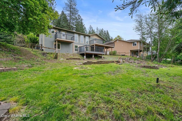 1303 N Cherrywood Dr, Coeur Dalene, ID 83814 - back of property featuring a balcony, a lawn, and a wooden deck