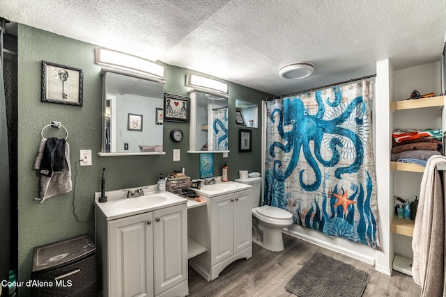 837 N 19th St, Coeur Dalene, ID 83814 - bathroom with a textured ceiling, a textured wall, wood finished floors, vanity, and toilet