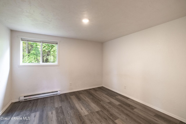 837 N 19th St, Coeur Dalene, ID 83814 - empty room with baseboard heating, dark wood-type flooring, and baseboards
