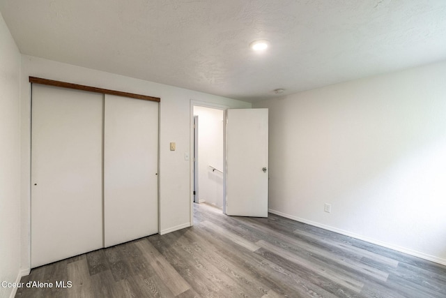 837 N 19th St, Coeur Dalene, ID 83814 - unfurnished bedroom with wood finished floors, baseboards, and a closet