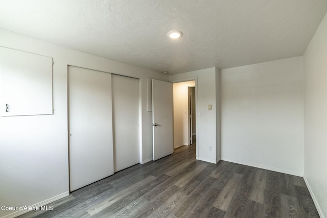 837 N 19th St, Coeur Dalene, ID 83814 - unfurnished bedroom with wood finished floors, a closet, baseboards, and a textured ceiling