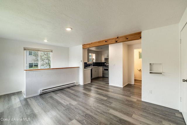 837 N 19th St, Coeur Dalene, ID 83814 - unfurnished living room featuring a baseboard heating unit, dark wood finished floors, baseboards, a textured ceiling, and recessed lighting