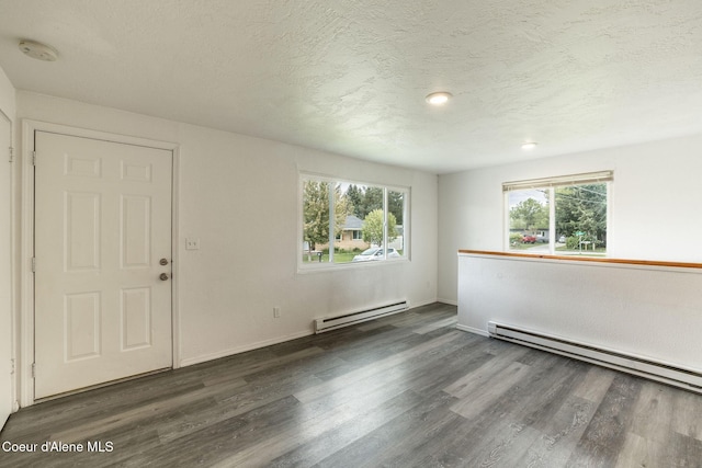 837 N 19th St, Coeur Dalene, ID 83814 - empty room with a baseboard heating unit, wood finished floors, plenty of natural light, and a textured ceiling