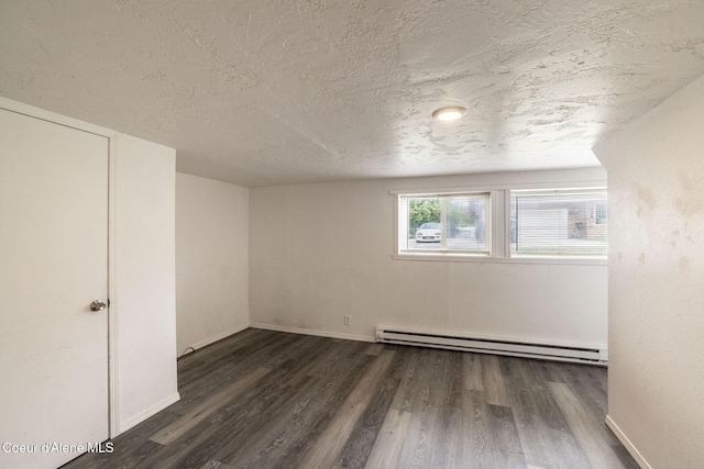 837 N 19th St, Coeur Dalene, ID 83814 - empty room with baseboard heating, wood finished floors, a textured ceiling, and baseboards