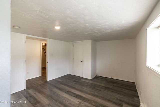 837 N 19th St, Coeur Dalene, ID 83814 - spare room with dark wood-style flooring, baseboards, a smoke detector, and a textured ceiling
