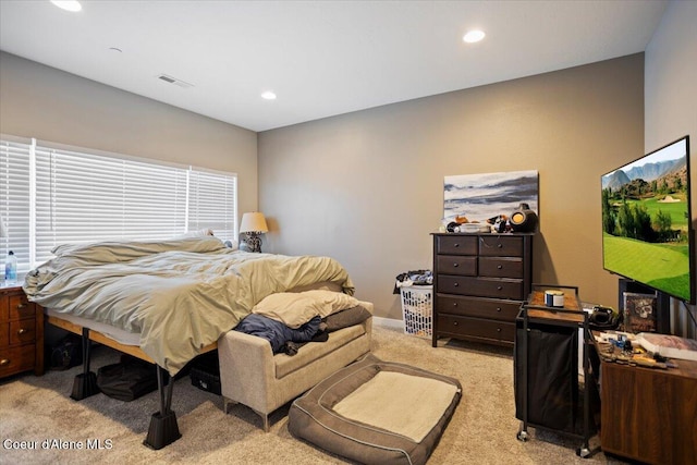 bedroom with light carpet and recessed lighting