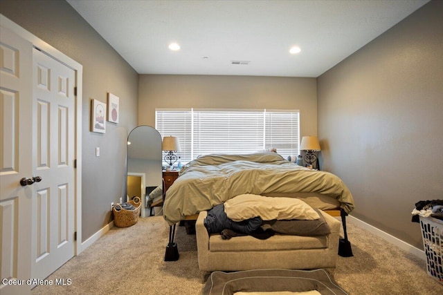 carpeted bedroom featuring baseboards and recessed lighting