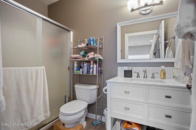 full bath featuring a stall shower, toilet, and vanity