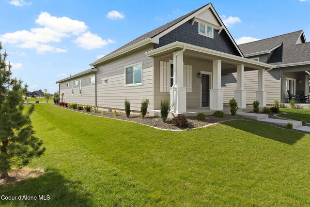 7823 N Girard Cir, Coeur Dalene, ID 83815 - view of property exterior featuring a yard, covered porch, and roof with shingles