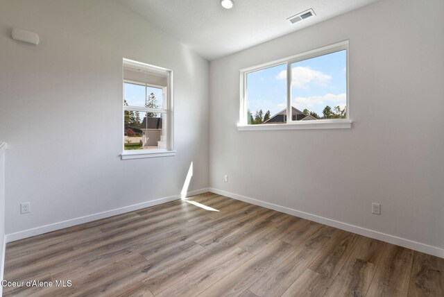 7823 N Girard Cir, Coeur Dalene, ID 83815 - empty room featuring wood finished floors, baseboards, and lofted ceiling
