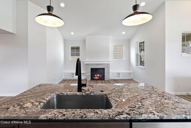 7823 N Girard Cir, Coeur Dalene, ID 83815 - kitchen featuring a sink, light stone countertops, wood finished floors, recessed lighting, and lofted ceiling