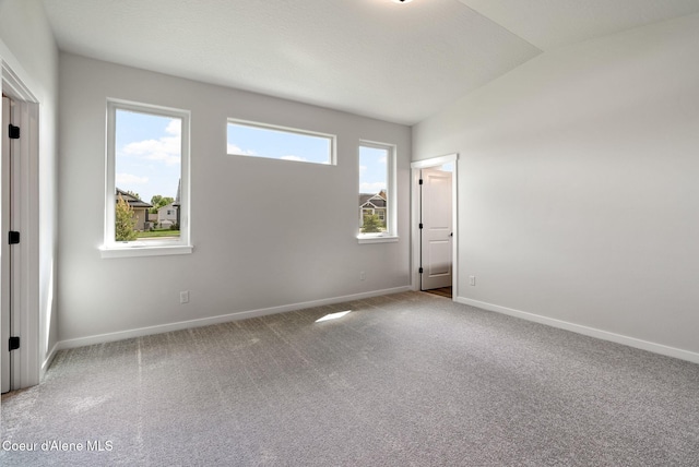 7823 N Girard Cir, Coeur Dalene, ID 83815 - unfurnished bedroom featuring baseboards, vaulted ceiling, and carpet floors
