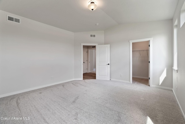 7823 N Girard Cir, Coeur Dalene, ID 83815 - unfurnished bedroom with lofted ceiling, carpet flooring, baseboards, a spacious closet, and a closet