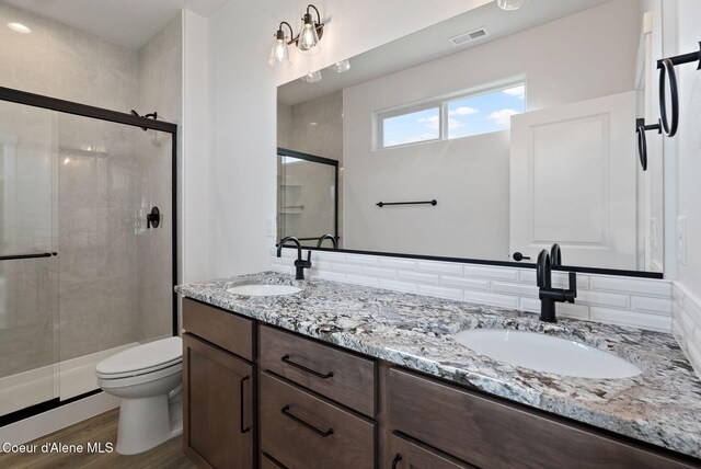 7823 N Girard Cir, Coeur Dalene, ID 83815 - full bath with a stall shower, toilet, double vanity, and wood finished floors