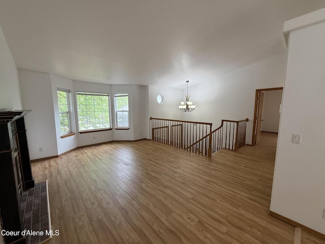 5188 E Woodland Dr, Post Falls, ID 83854 - unfurnished living room featuring a chandelier and wood finished floors