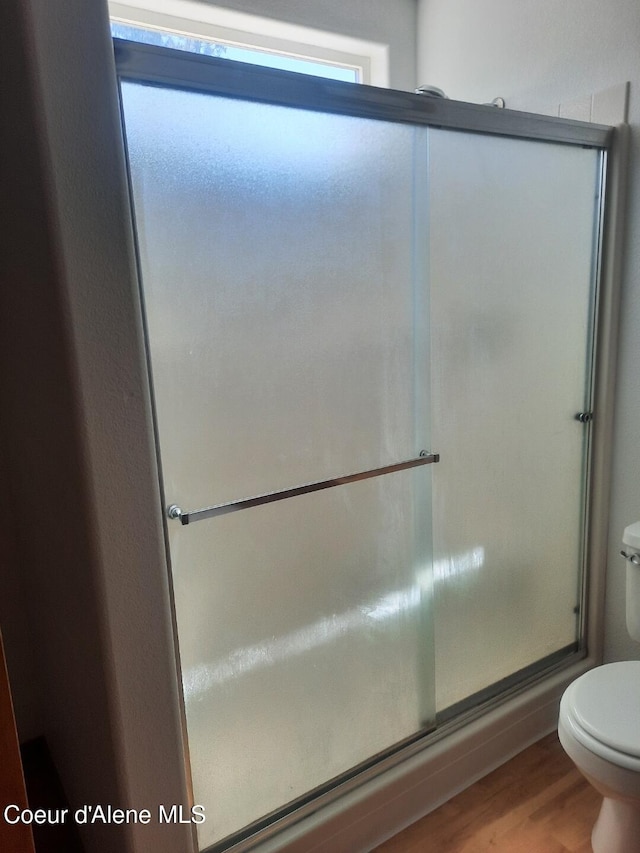 5188 E Woodland Dr, Post Falls, ID 83854 - full bath featuring wood finished floors and an enclosed shower