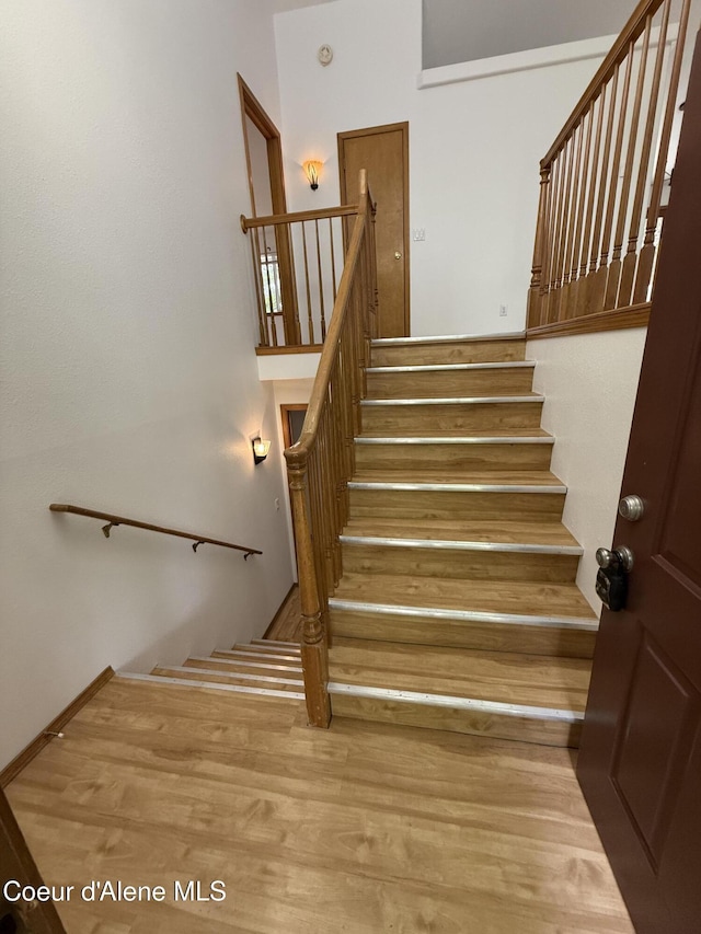 5188 E Woodland Dr, Post Falls, ID 83854 - staircase with wood finished floors and a high ceiling