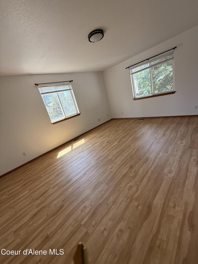 5188 E Woodland Dr, Post Falls, ID 83854 - spare room with plenty of natural light and wood finished floors