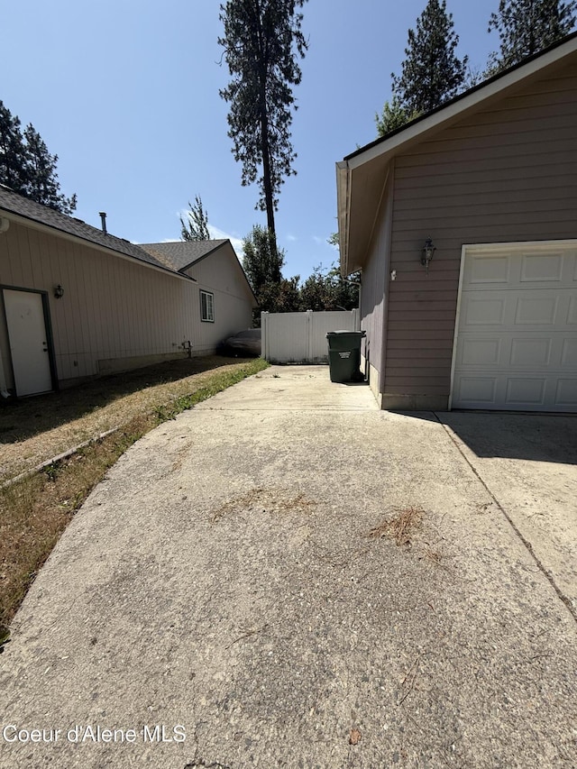5188 E Woodland Dr, Post Falls, ID 83854 - view of yard featuring concrete driveway and a garage
