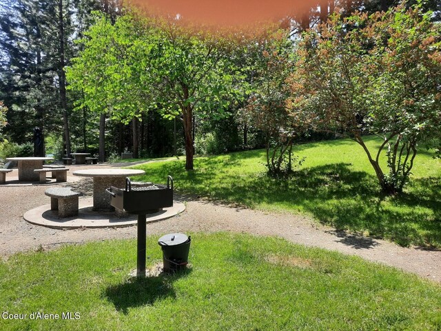 5188 E Woodland Dr, Post Falls, ID 83854 - view of property's community with a lawn and an outdoor fire pit