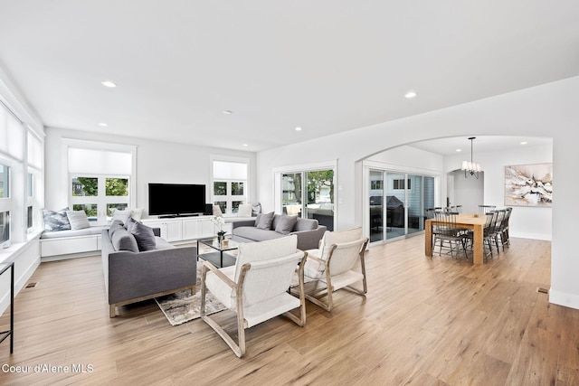 215 W Foster Ave, Coeur Dalene, ID 83814 - living area with arched walkways, recessed lighting, light wood finished floors, and a chandelier