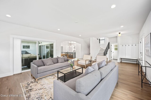 215 W Foster Ave, Coeur Dalene, ID 83814 - living room featuring arched walkways, stairway, wood finished floors, recessed lighting, and baseboards