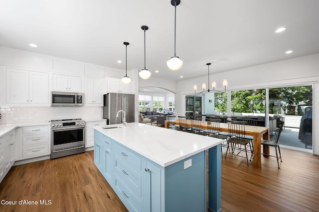 215 W Foster Ave, Coeur Dalene, ID 83814 - kitchen with appliances with stainless steel finishes, a sink, arched walkways, white cabinetry, and recessed lighting