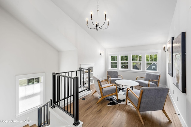 215 W Foster Ave, Coeur Dalene, ID 83814 - living area featuring an upstairs landing, wood finished floors, a chandelier, high vaulted ceiling, and baseboards