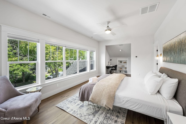 215 W Foster Ave, Coeur Dalene, ID 83814 - bedroom with multiple windows, wood finished floors, baseboards, and ceiling fan